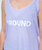 A person wearing a light purple tank top with the text 9ROUND printed in white across the front.