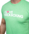 A close up of a man wearing a green i love kickboxing t-shirt showcasing the logo on the t-shirt