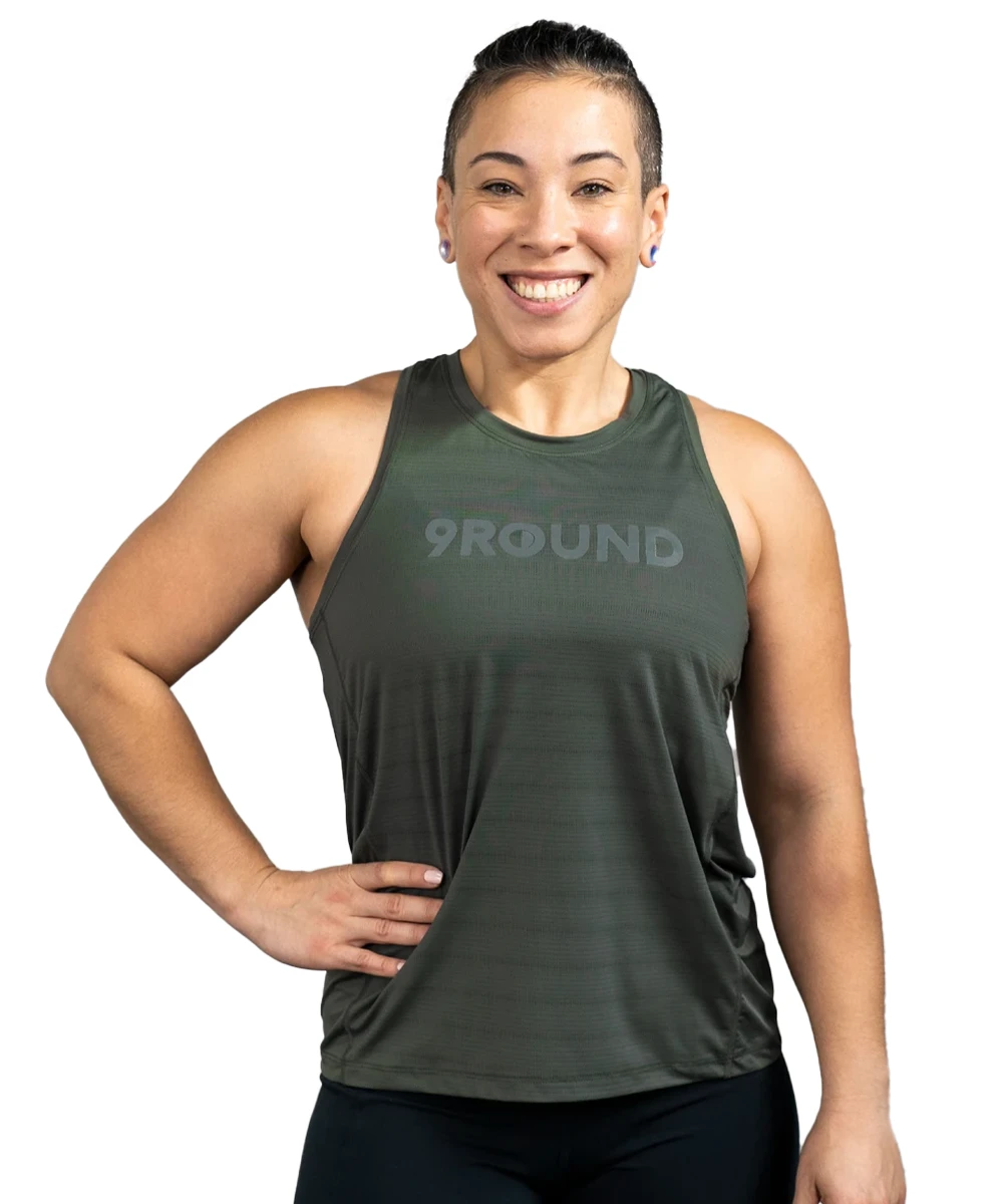 A woman with her hair up wearing a dark green mesh tank top with the 9Round logo in a matte grey on the upper chest area.