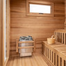 The inside of the 8-person sauna featuring the relaxing bench and Harvia sauna rocks.