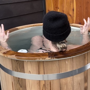 Lady in wearing a Beanie enjoying her Alaskan Cold Plunge