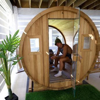 Person enjoying their Redwood Outdoors barrel sauna