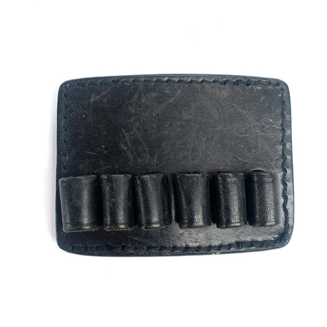 Price Western Leather (PWL) 6 Rounds Belt Mounted Ammo Carrier, designed to securely hold ammunition on a belt for easy access. The carrier is made of high-quality leather and features slots to accommodate six rounds of ammunition. It attaches to a belt with sturdy loops, providing a convenient and reliable method for carrying spare rounds during shooting activities. Ideal for hunters, sport shooters, and firearm enthusiasts.
