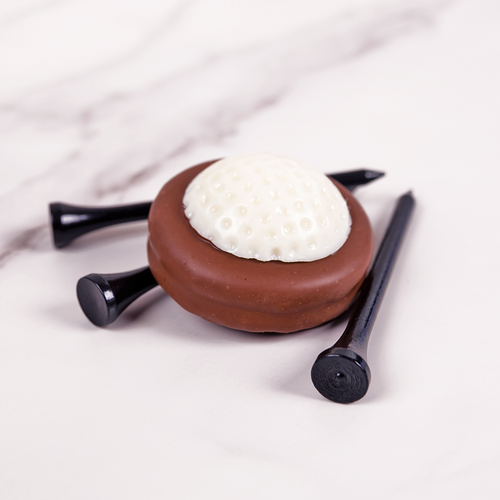 White Chocolate Golf Ball with an Oreo covered in our Milk Chocolate.