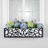 French Quarter Cast Aluminum Window Box with white pvc liner mounted under a window