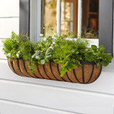 English garden hayrack mounted below a window English garden hayrack mounted below a window