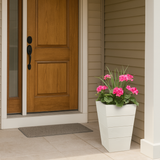 Madera Fiberglass Tapered Square Planter in white semi-gloss on a porch by a front door