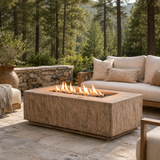 Basoa fire table shown with antigua finish with grove of pine trees in background