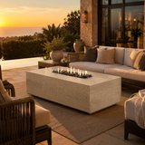 Zaragoza fire table shown with tiza finish with palm tree and ocean in background