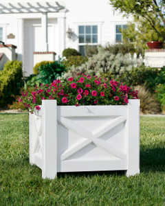 Main Street planter planted with red flowers