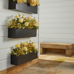 3 Black Modern Window Boxes mounted to all wall with tan and gold flowers 3 Black Modern Window Boxes mounted to all wall with tan and gold flowers