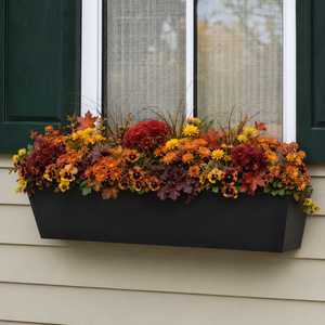 Black Galvanized 2-in-1 Metal Tapered Window Box or Liner installed under a window with fall flowers planted inside box