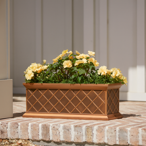 Copper ArmoreCoat La Fleur Window Box with gold flowers on a used brick porch Copper ArmoreCoat La Fleur Window Box with gold flowers on a used brick porch
