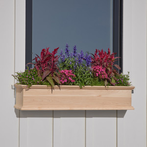 Laguna Cedar Window Box mounted under a window with purple and hot pink flowers