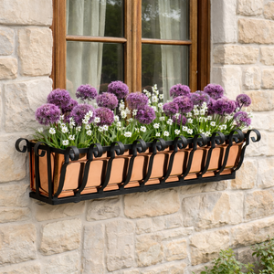 Pacific Heights Copper Window Box with purple flowers mounted under a window