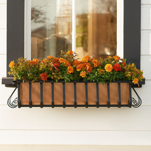 European Window Box with copper liner under a window with fall flowers