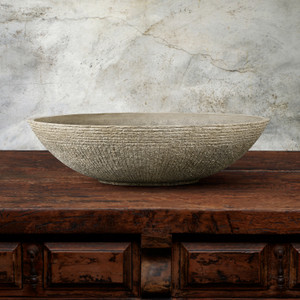 Zaragoza Tabletop Vessel in Chenza finish on a wood table with gray background
