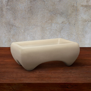 Molcajete Bowl in natural finish on wood table with gray background Molcajete Bowl in natural finish on wood table with gray background