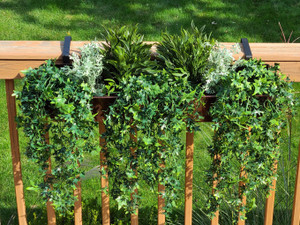 Outdoor Rated Artificial Green Vines and Bush Bundles for Window Boxes on a wood railing Outdoor Rated Artificial Green Vines and Bush Bundles for Window Boxes on a wood railing