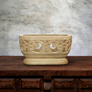 Oaxacan Oval Orchid Planter in Tiza finish on wood counter top with gray backgound
