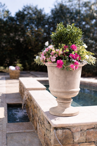 Imperial Urn in Tiza finish measuring 30" in diameter x 37" in height on the edge of a pool.