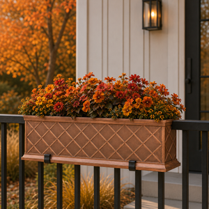 La Fleur fiberglass window box coated with liquid copper filled with fall foliage on a railing in front of a home