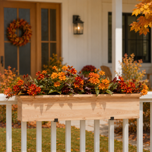 Newport Cedar railing planter on  a wood railing with fall flowers with a porch in background