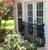 Bellissimo faux balcony attached to side of house with French doors.