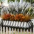 European Railing Planter with fall foliage in white liner on fence with lavender in background
