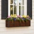 Simple Elegance window box with bronze liner planted with spring flowers on a traditional home with black shutters.