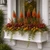 Laguna Cleat Mount Window Box filled with fall foliage shown with decorative faux brackets on a home
