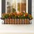 European Window Box with copper liner under a window with fall flowers