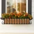 European Window Box with copper liner under a window with fall flowers