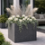 Strato Fiberstone Planter in Zinc finish  on a patio with white flowers and trailing ivy