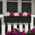 Falling Water Railing Planter on white railing planted with pink and white flowers