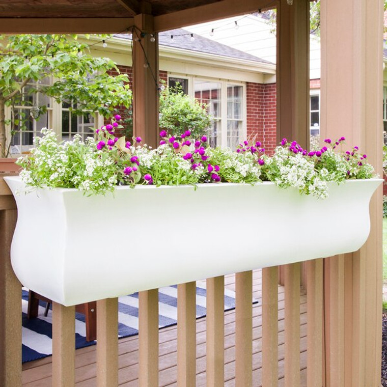 48" White Parada Railing Planter on a natural colored deck  rail planted with bright pink and white flowers