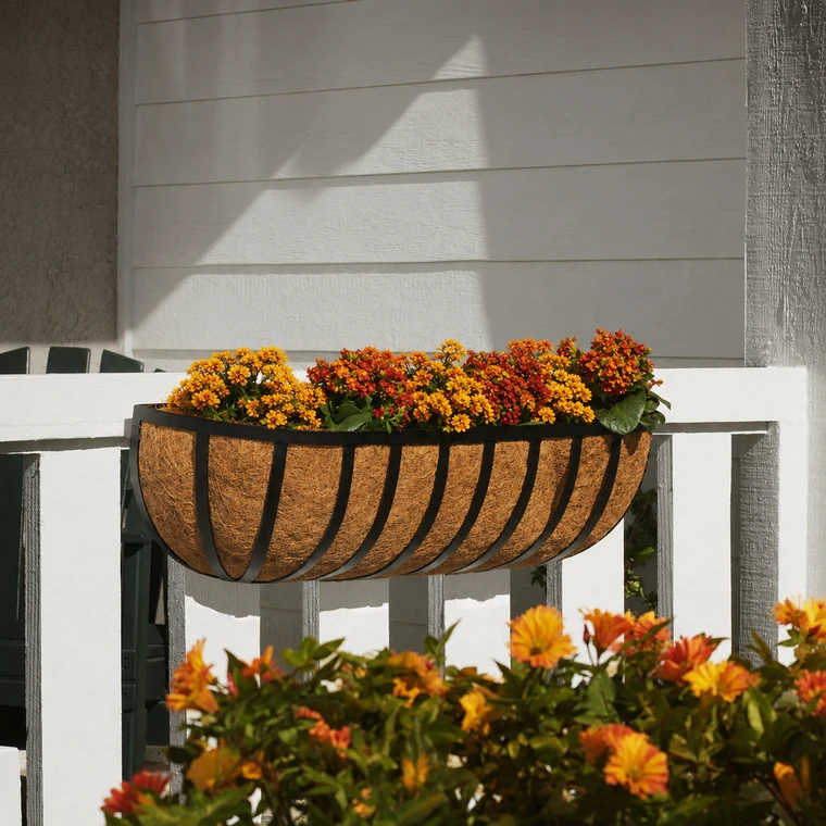 XL English Garden Hayrack on white railing with fall foliage