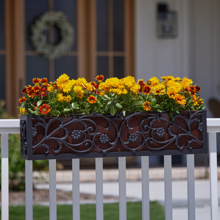 French Quarter Cast Aluminum Window Box with oil rubbed galvanized liner on railing with gold and orange flowers