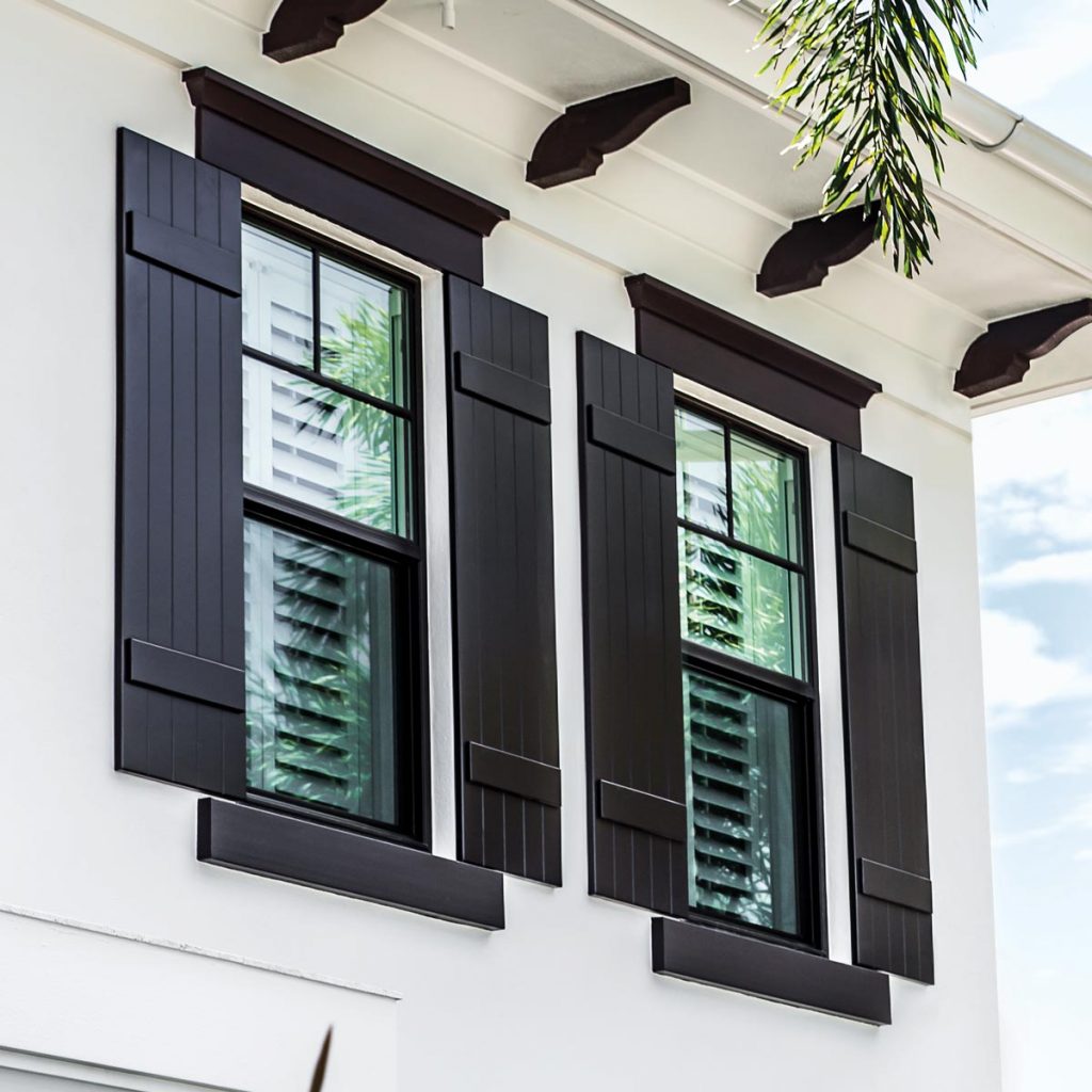 Black shutters on white home with black trim around windows