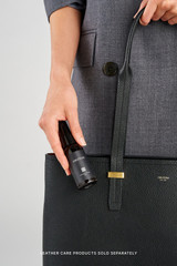 Profile view of model wearing the Oroton Anika 15" Tote & Cover in Black and Premium pebble leather for Women .