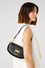 Profile view of model wearing the Oroton Colt Small Baguette in Black and Smooth leather for Women . IP:2