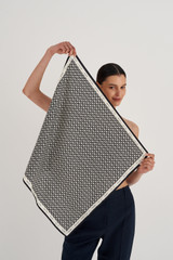 Profile view of model wearing the Oroton All Over Logo Silk Scarf in Cream/Black and 100% Silk for Women .