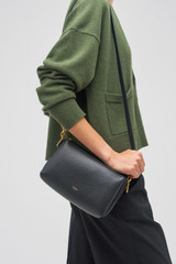 Profile view of model wearing the Oroton Alice Crossbody in Black and Pebble Leather for Women