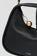 Profile view of model wearing the Oroton Clara Mini Bag in Black and Pebble leather for Women . IP:5