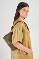 Profile view of model wearing the Oroton Astrid Shoulder Bag in Olive and Pebble Leather for Women