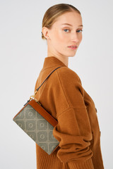Profile view of model wearing the Oroton Harvey Signature Baguette Crossbody in Black/Cognac and Nylon canvas base cloth material with PVC coating (70% PVC, 30% polyester) for Women .