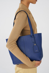 Profile view of model wearing the Oroton Lilly Small Shopper Tote in Azure Blue and Pebble Leather for Women