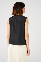 Profile view of model wearing the Oroton Silk Shell Top in Black and 92% silk, 8% spandex for Women