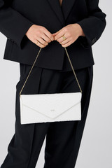 Profile view of model wearing the Oroton Louisa Clutch in Pure White and Italian embossed leather for Women