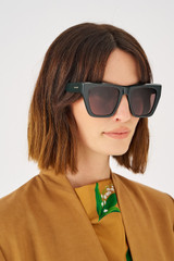 Profile view of model wearing the Oroton Cullen Sunglasses in Treehouse and Acetate for 